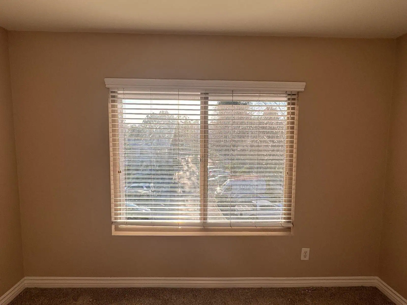 Interior wall with window and blinds, ready for painting or renovation.