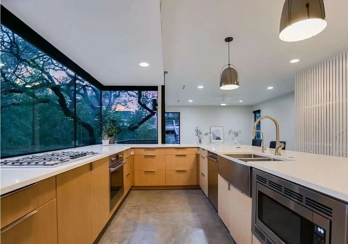 Bright, contemporary kitchen featuring large windows and modern fixtures.